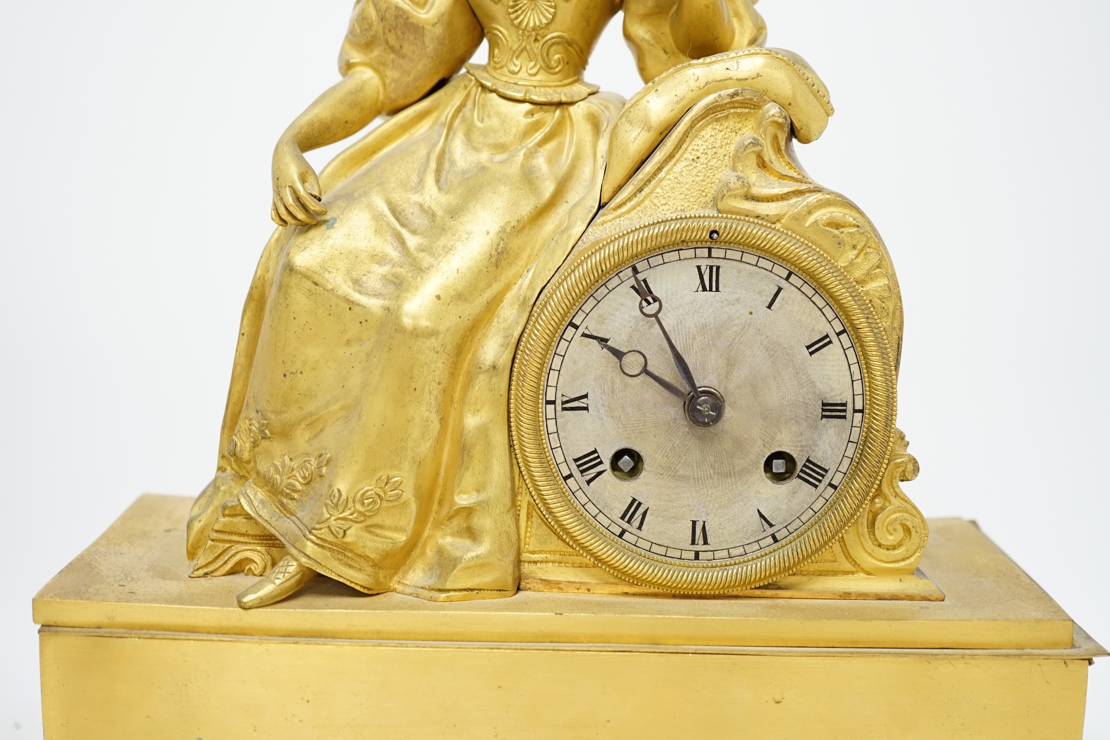A 19th century French ormolu mantel clock, surmounted with a lady, with key and pendulum, 36cm high. Condition - poor